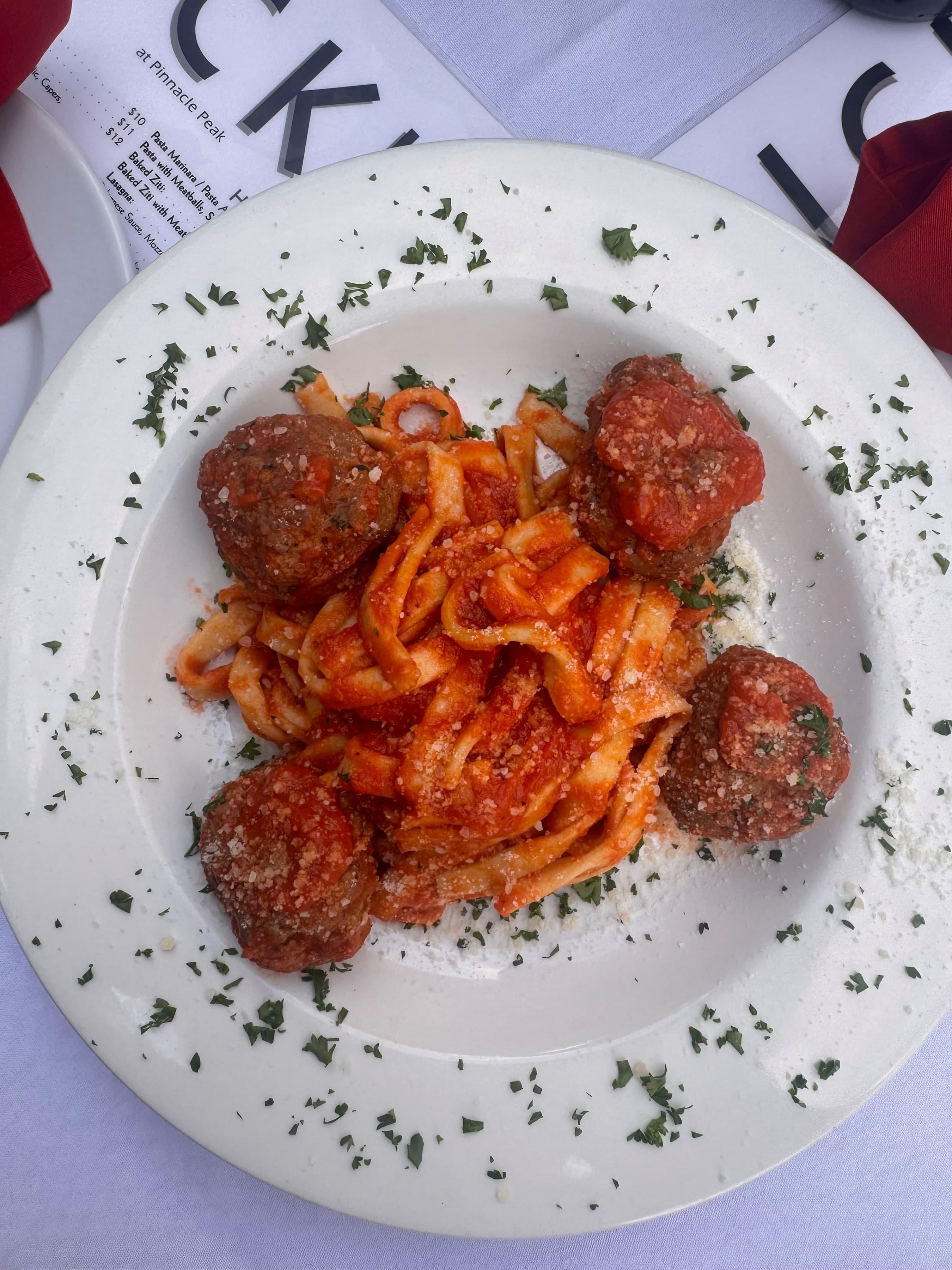 Pasta with marinara, meatballs, and parmesan plated at Nick's at Frank Lloyd Wright.